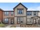 Charming townhome featuring neutral siding, trim, and tidy front yard landscaping at 11440 E Martin Luther King Jr Blvd, Denver, CO 80238