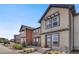 View of a series of modern townhomes with a sidewalk and tidy landscaping at 11440 E Martin Luther King Jr Blvd, Denver, CO 80238