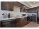 Efficient kitchen featuring dark cabinetry, modern appliances, and light countertops at 11440 E Martin Luther King Jr Blvd, Denver, CO 80238