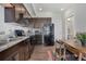 Kitchen area with sleek cabinets, modern appliances, and an adjacent dining space at 11440 E Martin Luther King Jr Blvd, Denver, CO 80238
