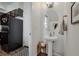 Powder room adjacent to kitchen featuring a pedestal sink and decorative mirror at 11440 E Martin Luther King Jr Blvd, Denver, CO 80238