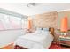 Cozy bedroom with brick accent wall, large windows, and ample natural light at 3050 S Marion St, Englewood, CO 80113