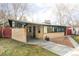 Brick exterior home featuring a covered carport with a well-manicured lawn at 3050 S Marion St, Englewood, CO 80113