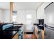 View of the kitchen area featuring brick walls, modern cabinets, and stainless steel appliances at 3050 S Marion St, Englewood, CO 80113