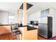 Bright kitchen features modern appliances, wood floors, breakfast bar, and light wood cabinetry at 3050 S Marion St, Englewood, CO 80113