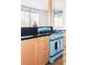 Kitchen showcasing custom cabinetry, hardwood floors, and a unique oven range at 3050 S Marion St, Englewood, CO 80113
