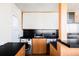 Modern kitchen with stainless steel appliances, wood cabinets, and access to backyard at 3050 S Marion St, Englewood, CO 80113