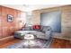 Inviting living room boasts hardwood floors, brick accent wall, modern art, and comfortable seating at 3050 S Marion St, Englewood, CO 80113