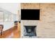 A brick fireplace anchors the living and dining spaces with views from large windows at 3050 S Marion St, Englewood, CO 80113