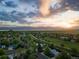 Stunning aerial view showcases neighborhood and lush landscape near a lake with sunset views at 9346 Flower St, Broomfield, CO 80021