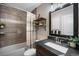 Stylish bathroom featuring a tiled shower, modern vanity, and decorative shelving at 9346 Flower St, Broomfield, CO 80021