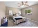 Inviting bedroom featuring a ceiling fan, plush bedding, and bedside tables with lamps at 9346 Flower St, Broomfield, CO 80021