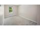 Bright bedroom features neutral walls, carpet flooring, and a window with natural light at 9346 Flower St, Broomfield, CO 80021