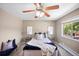 Inviting bedroom featuring a ceiling fan, plush bedding, and bedside tables with lamps at 9346 Flower St, Broomfield, CO 80021