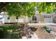 Charming home with a stone walkway, manicured lawn, and mature shade tree at 9346 Flower St, Broomfield, CO 80021