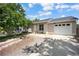 Well-maintained home with a two-car garage and landscaped front yard at 9346 Flower St, Broomfield, CO 80021
