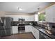 Modern kitchen with stainless steel appliances, white cabinets, and dark countertops at 9346 Flower St, Broomfield, CO 80021
