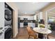 Well-designed kitchen with stainless steel appliances and breakfast nook leading to laundry closet at 9346 Flower St, Broomfield, CO 80021
