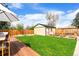 Beautiful backyard with a well-maintained lawn, shed, and dining area at 2120 N Poplar St, Denver, CO 80207