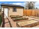 Backyard with raised garden beds, garden shed, and gravel pathway at 2120 N Poplar St, Denver, CO 80207