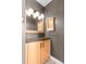 Bathroom vanity with light wood cabinetry and modern mirror at 2120 N Poplar St, Denver, CO 80207