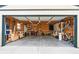 Spacious garage featuring built-in storage, workbenches, and ample room for parking and projects at 2120 N Poplar St, Denver, CO 80207