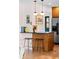 Bright kitchen bar area with seating and stainless steel refrigerator at 2120 N Poplar St, Denver, CO 80207
