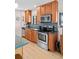 Updated kitchen with stainless steel appliances, wooden cabinets, and natural lighting at 2120 N Poplar St, Denver, CO 80207