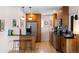 Well-lit kitchen with modern appliances, wooden cabinets, and a breakfast bar at 2120 N Poplar St, Denver, CO 80207
