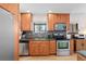 Bright kitchen featuring modern appliances, wooden cabinets, and tiled backsplash at 2120 N Poplar St, Denver, CO 80207