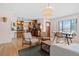 Open-concept living area with a kitchen view, hardwood floors, and natural light at 2120 N Poplar St, Denver, CO 80207