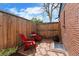 Charming brick patio with red Adirondack chairs perfect for outdoor relaxation at 2120 N Poplar St, Denver, CO 80207