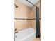 Bathtub and shower combination, and tiled walls with black shower curtain at 2120 N Poplar St, Denver, CO 80207