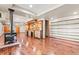 Spacious finished basement with bar, wood-burning stove, wood floors, and shelving at 1988 Lake Dr, Larkspur, CO 80118