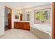 Bright and spacious bathroom with double vanity, soaking tub, and walk in closet at 1988 Lake Dr, Larkspur, CO 80118