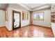 Bonus room with hardwood floors, natural light, and unique glass door with etched detailing at 1988 Lake Dr, Larkspur, CO 80118