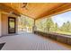 Beautiful outdoor deck with wood ceiling, modern fireplace feature, and a stunning view of the forest at 1988 Lake Dr, Larkspur, CO 80118