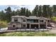 Rear exterior of home shows a multi-tiered deck and mountain views at 1988 Lake Dr, Larkspur, CO 80118