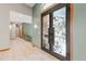 Grand foyer with tile flooring, decorative front door, and open staircase at 1988 Lake Dr, Larkspur, CO 80118