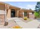 Stucco home with stone accents featuring an elegant front door and manicured landscaping at 1988 Lake Dr, Larkspur, CO 80118