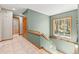 Beautifully designed hallway with tile floors and wooden trim, leading to multiple rooms and a staircase at 1988 Lake Dr, Larkspur, CO 80118