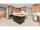 Spacious kitchen featuring custom cabinetry, granite counters, stainless appliances, and tile floors at 1988 Lake Dr, Larkspur, CO 80118