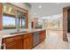 Open-concept kitchen with granite countertops, wooden cabinetry, and stainless steel dishwasher at 1988 Lake Dr, Larkspur, CO 80118