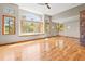 Bright living room with high ceilings, wooden floors, and scenic views from the large windows at 1988 Lake Dr, Larkspur, CO 80118