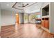 Spacious living room with fireplace, wood floors, a decorative ceiling fan, and natural light at 1988 Lake Dr, Larkspur, CO 80118