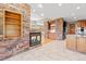 Open concept living area featuring a fireplace, stone accents, and kitchen access at 1988 Lake Dr, Larkspur, CO 80118