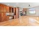 Open living area featuring wood flooring, custom cabinets, and a stone fireplace at 1988 Lake Dr, Larkspur, CO 80118