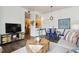 Cozy living room with a unique wooden coffee table and an open layout flowing into the kitchen at 2708 Syracuse St # 109, Denver, CO 80238