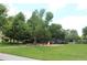 Playground area within the community's green space with trees and shade at 2708 Syracuse St # 109, Denver, CO 80238