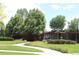 Inviting entrance to the community pool area with lush landscaping at 2708 Syracuse St # 109, Denver, CO 80238